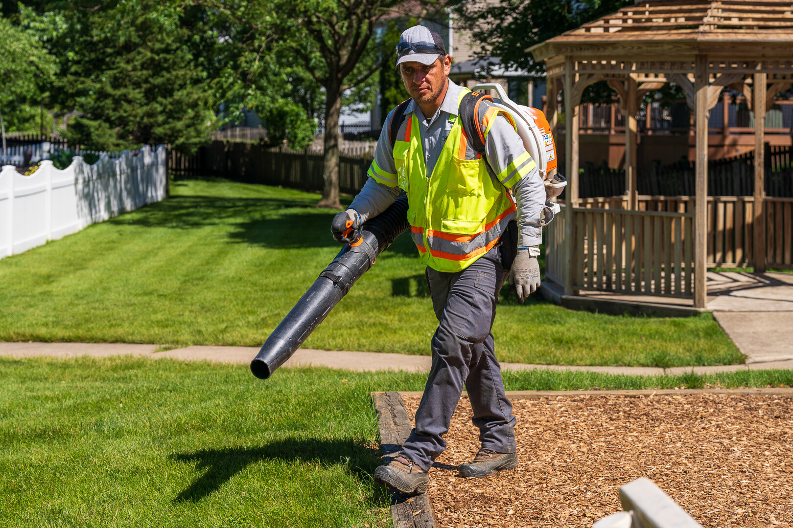 commercial landscape maintenance technician blowing debris