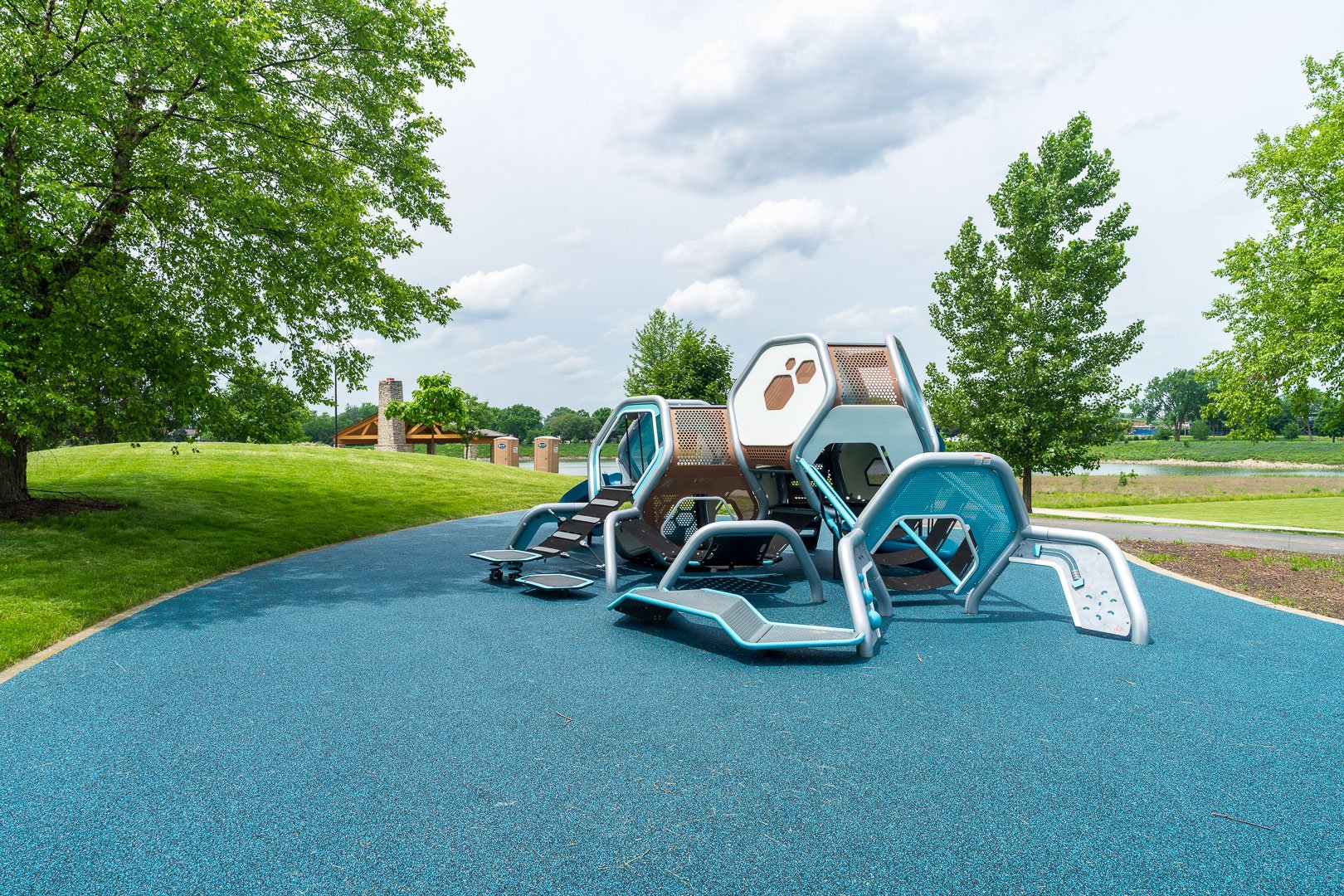 commercial sculpture with shade trees and lawn playground