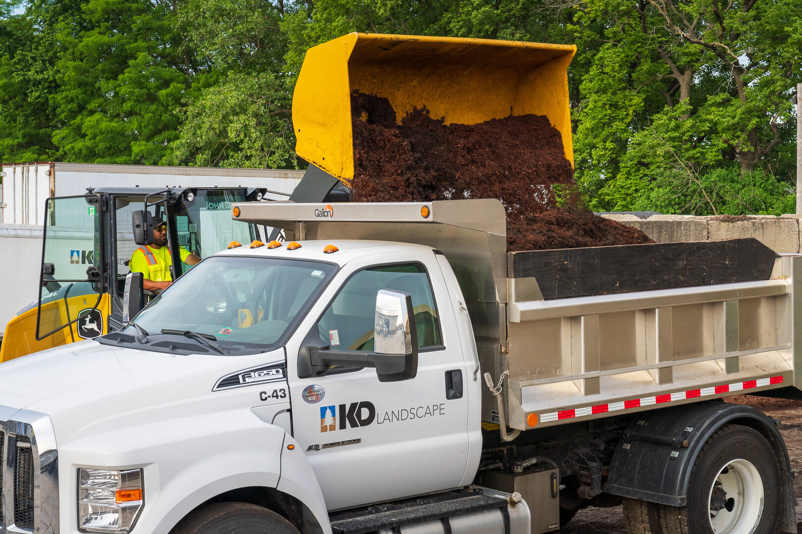 loading dump truck with mulch at garage in morning 5