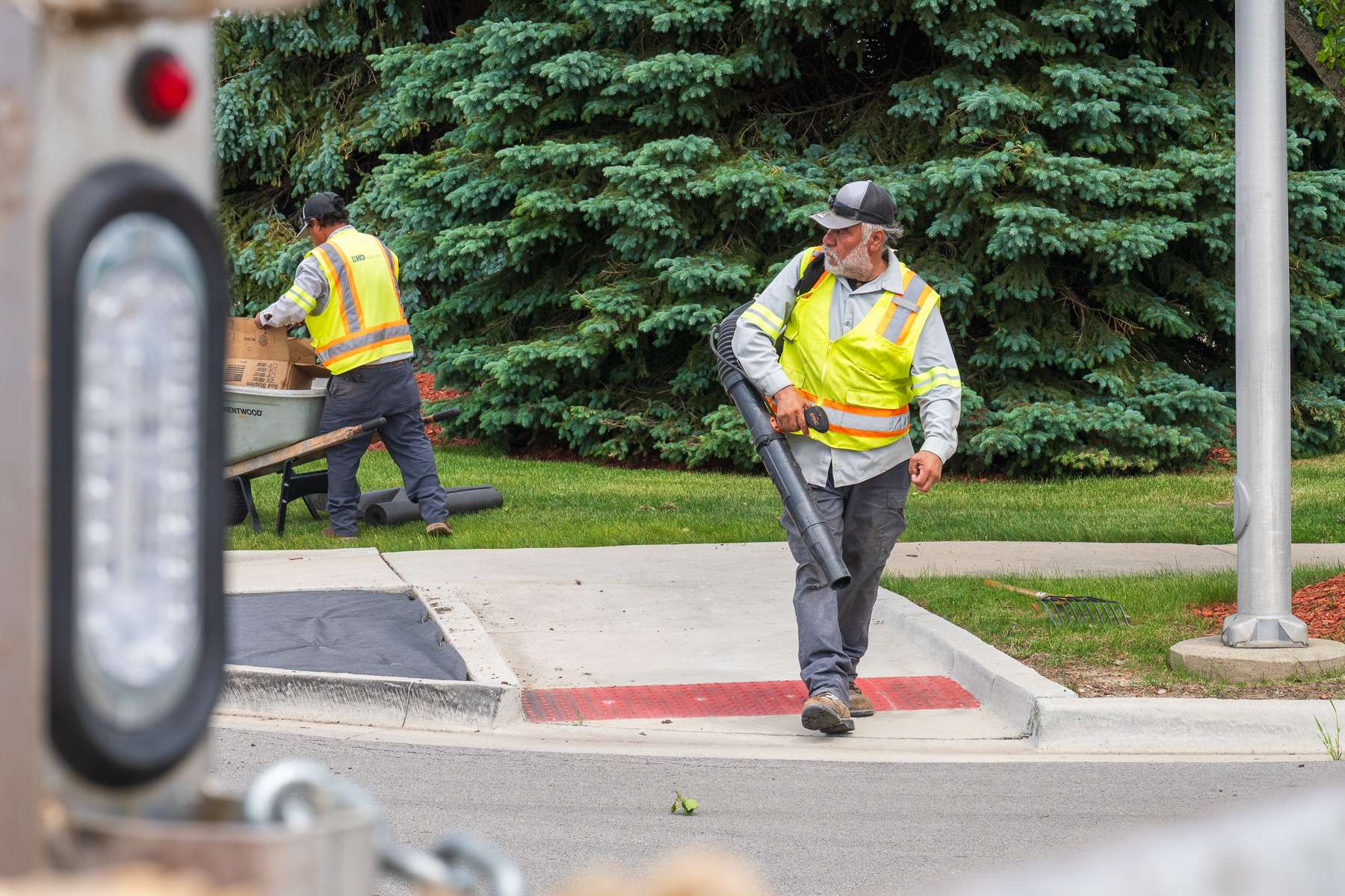 commercial enhancements crew installing river rock parking lot island bed 5
