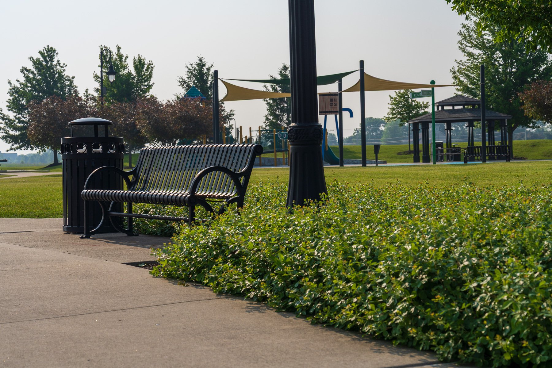 municipal park landscaping with plants and bench