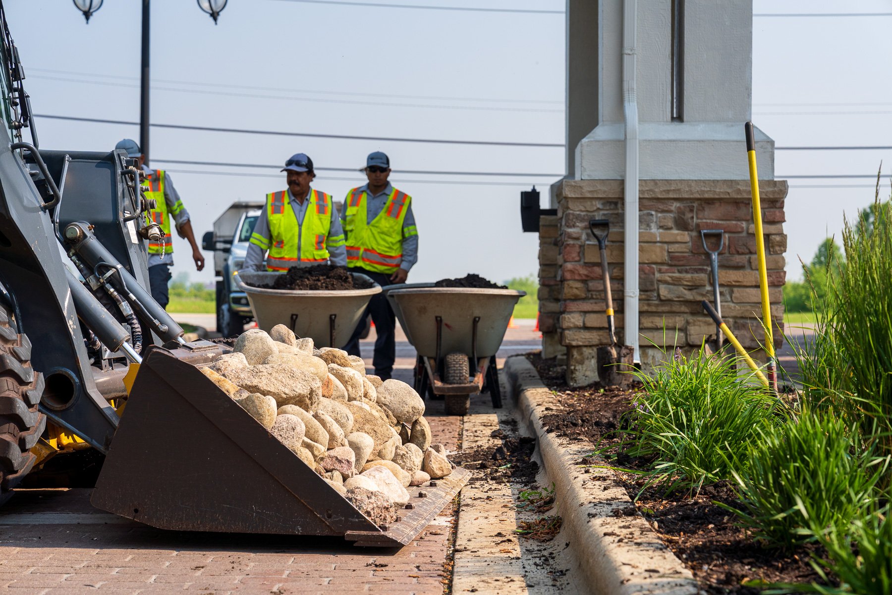 hoa enhancements crew team planting grading soil mulch rock machine 3