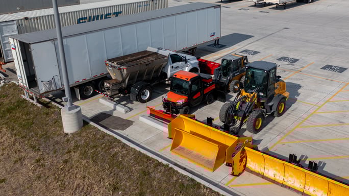 industrial warehouse parking lot aerial snow equipment before a storm 2