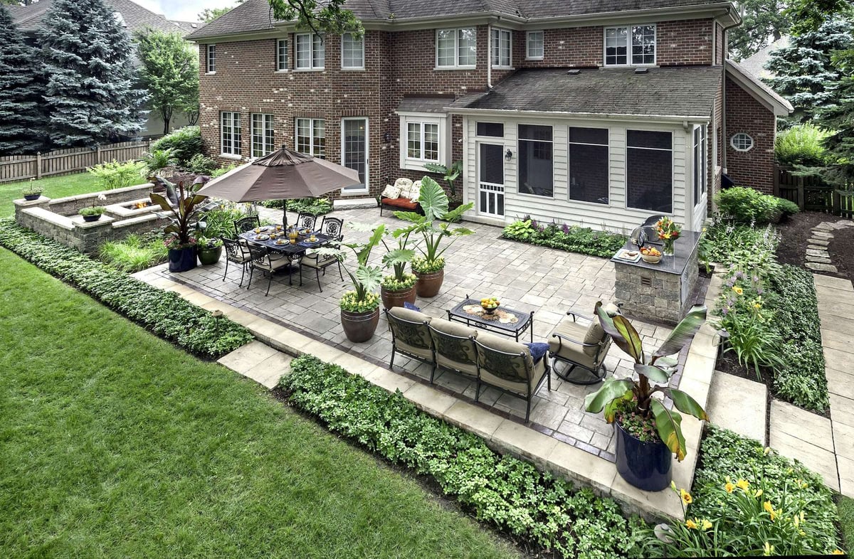 outdoor kitchen and patio with plantings and container gardens