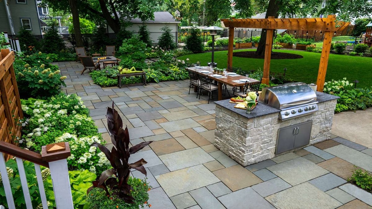 outdoor kitchen area with seating and pergola