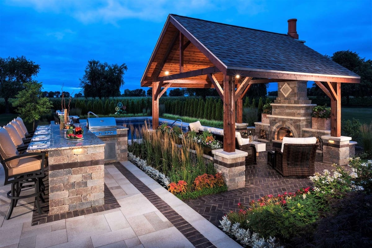 outdoor kitchen with pool pavilion and fireplace