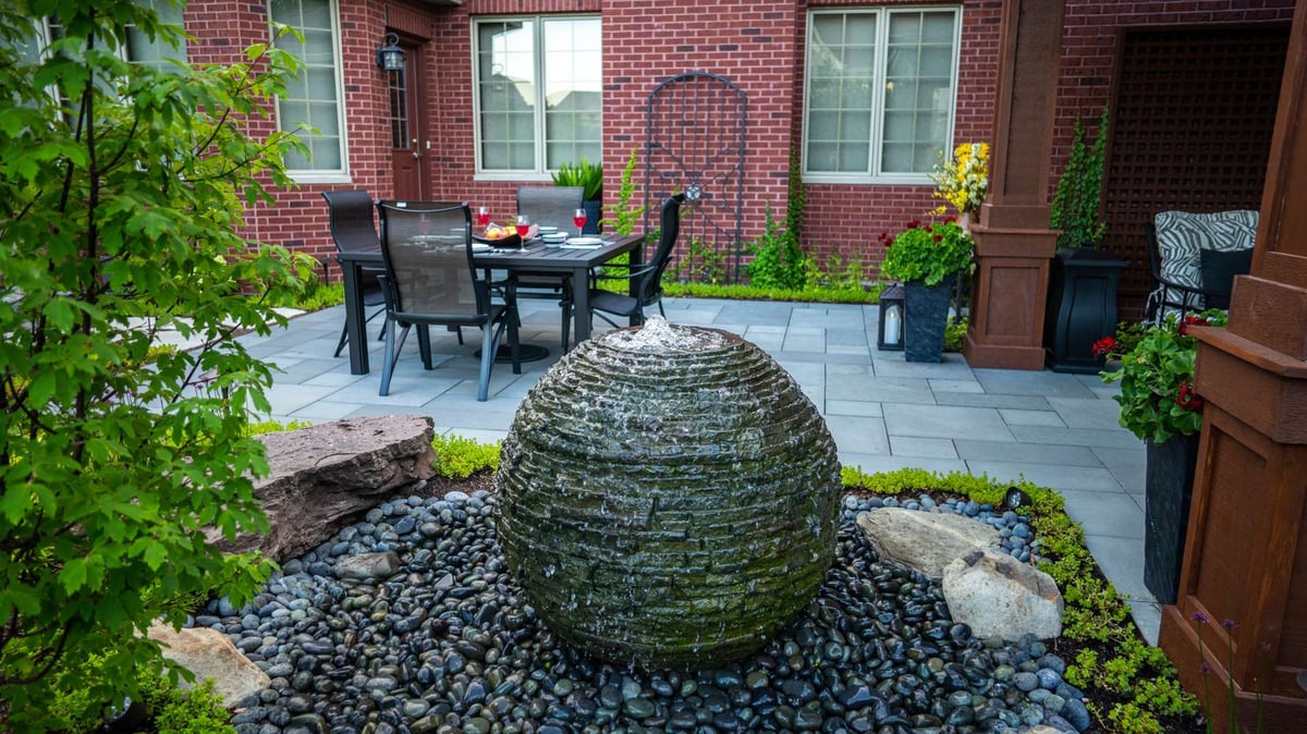 Water feature on patio with seating and pavilion