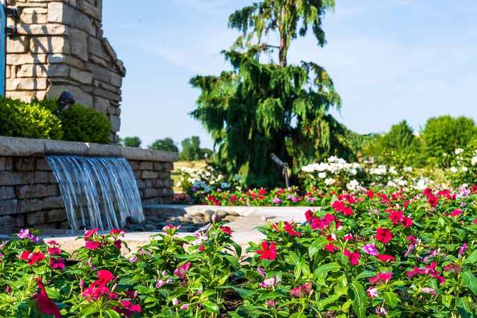 flowers and water feature at signage