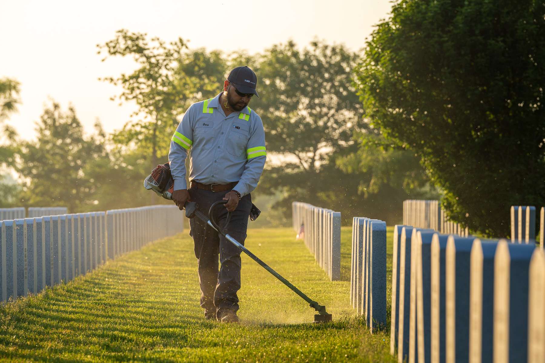 commercial landscape maintenance technician trimming cemetary 2