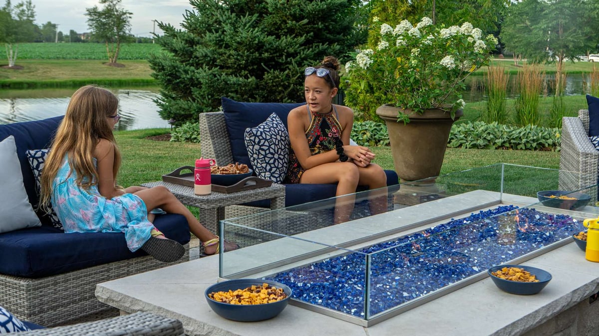 children sit around fire table with snacks