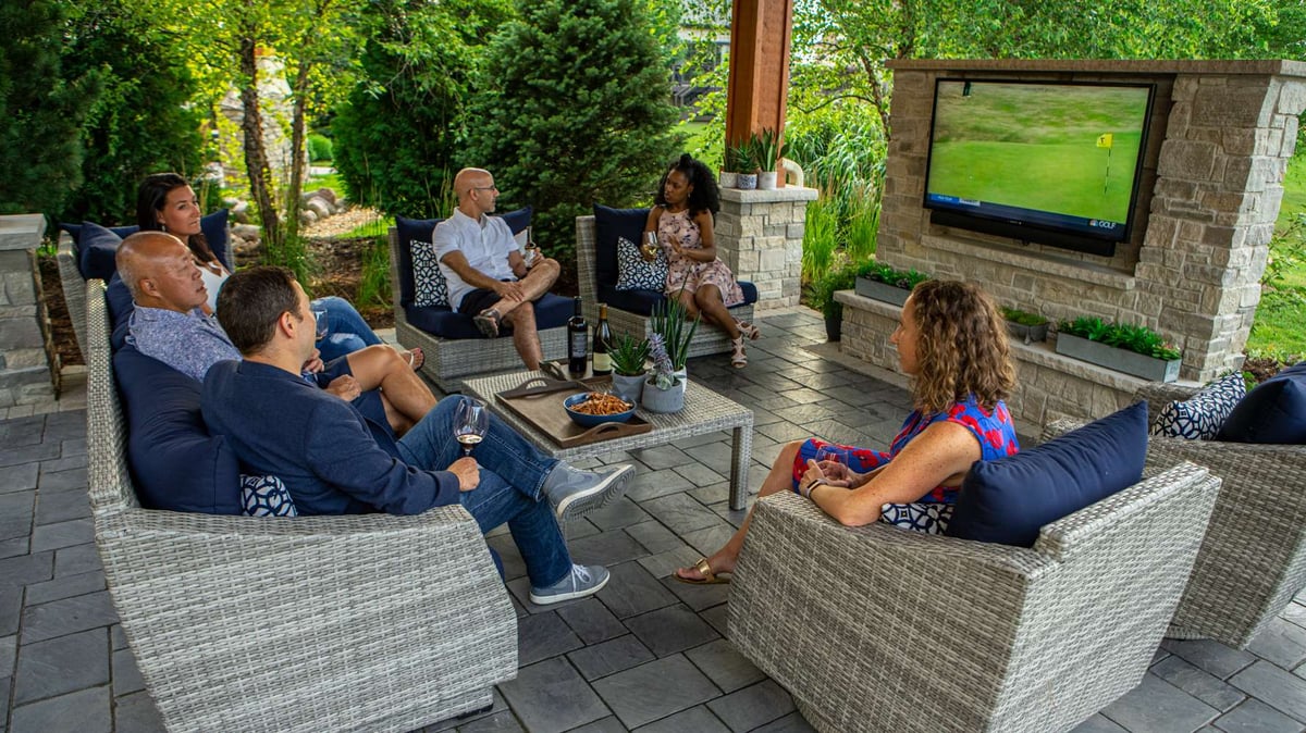 people sitting under pavilion outdoors watching television