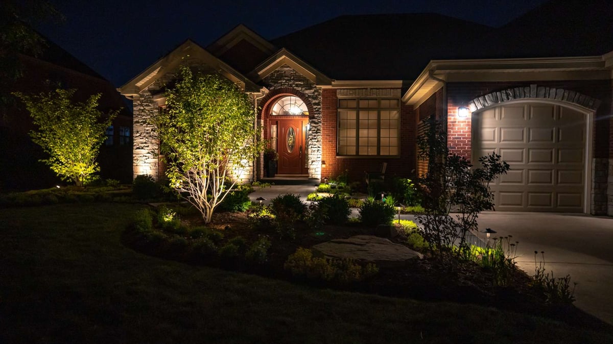 home entrance and walkway lit with landscape lighting