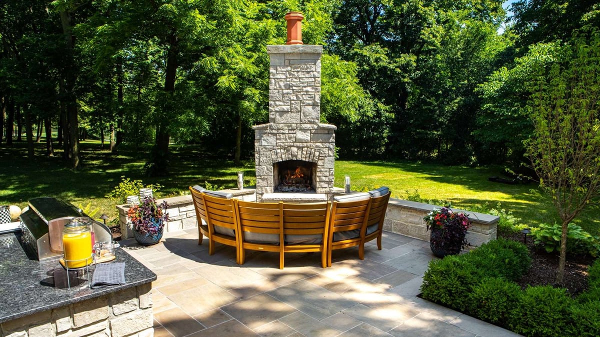 outdoor fireplace with seating and outdoor kitchen