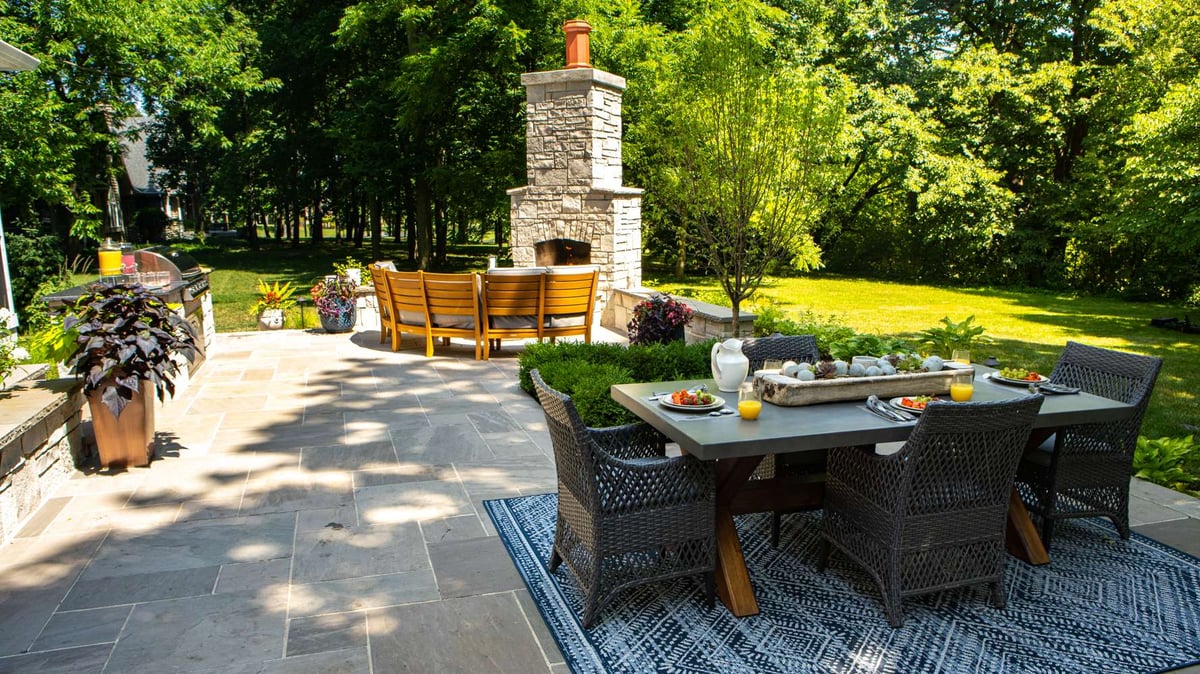 outdoor kitchen with patio and seating area and fireplace