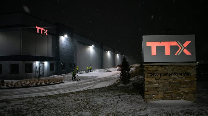 commercial snow removal team removing snow from a commercial facility entryway
