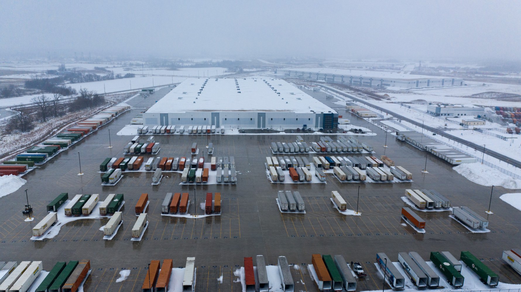 aerial view of commercial facility parking lot showing completed snow removal service