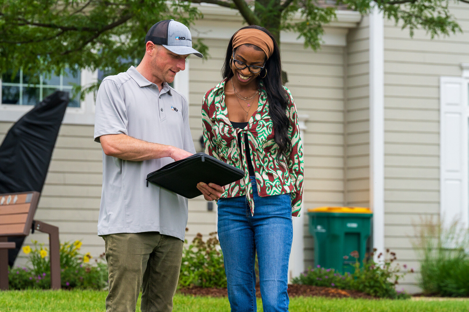 hoa manager and landscape account manager reviewing a contract