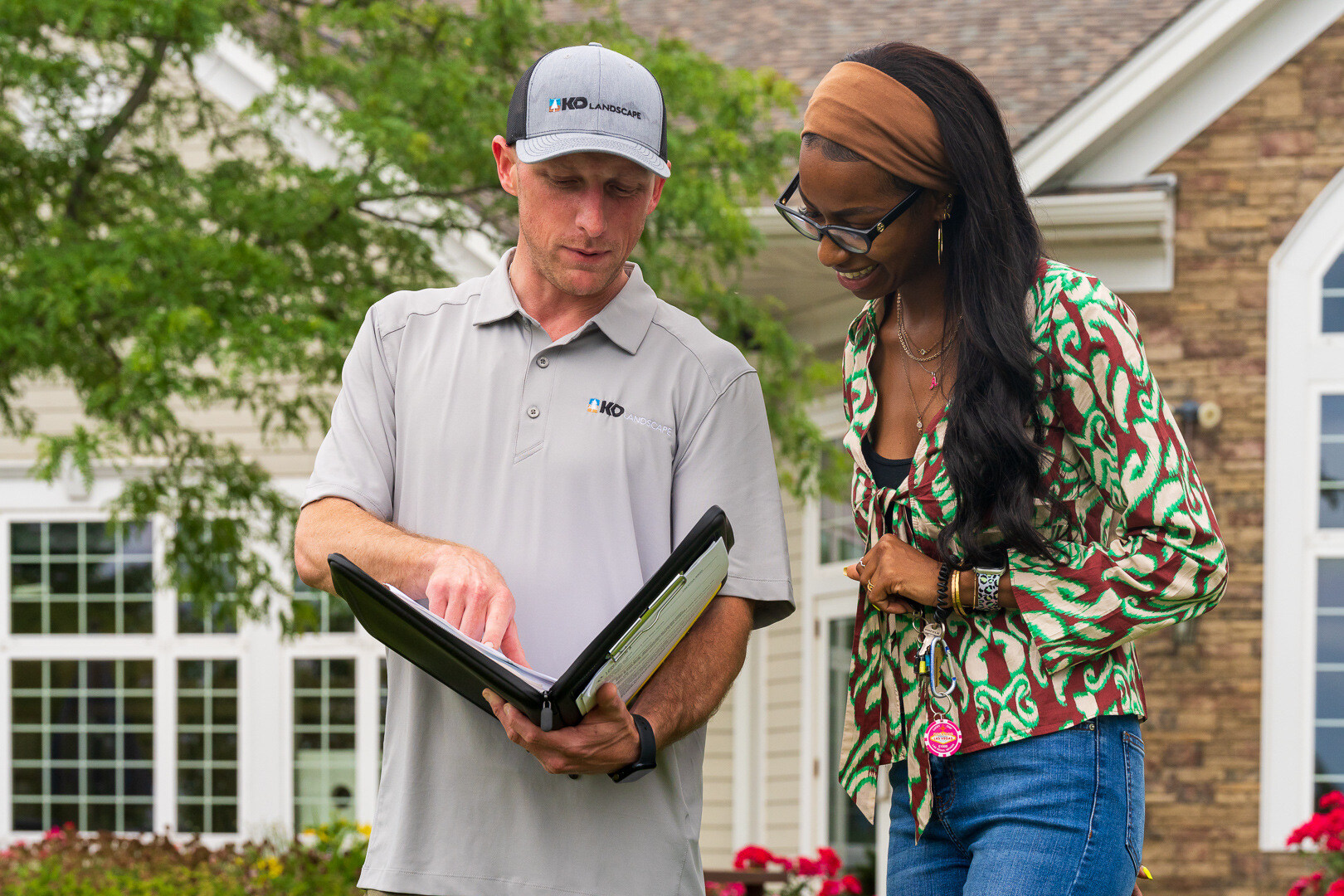 property manager and landscape account manager reviewing a contract