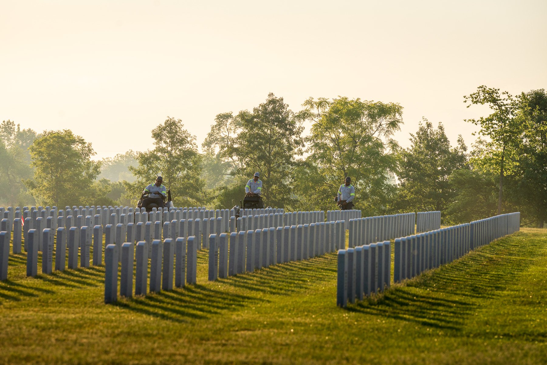 commercial maintenance technician mowing cemetary 18