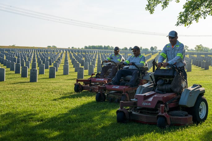 commercial landscape maintenance team mows grass