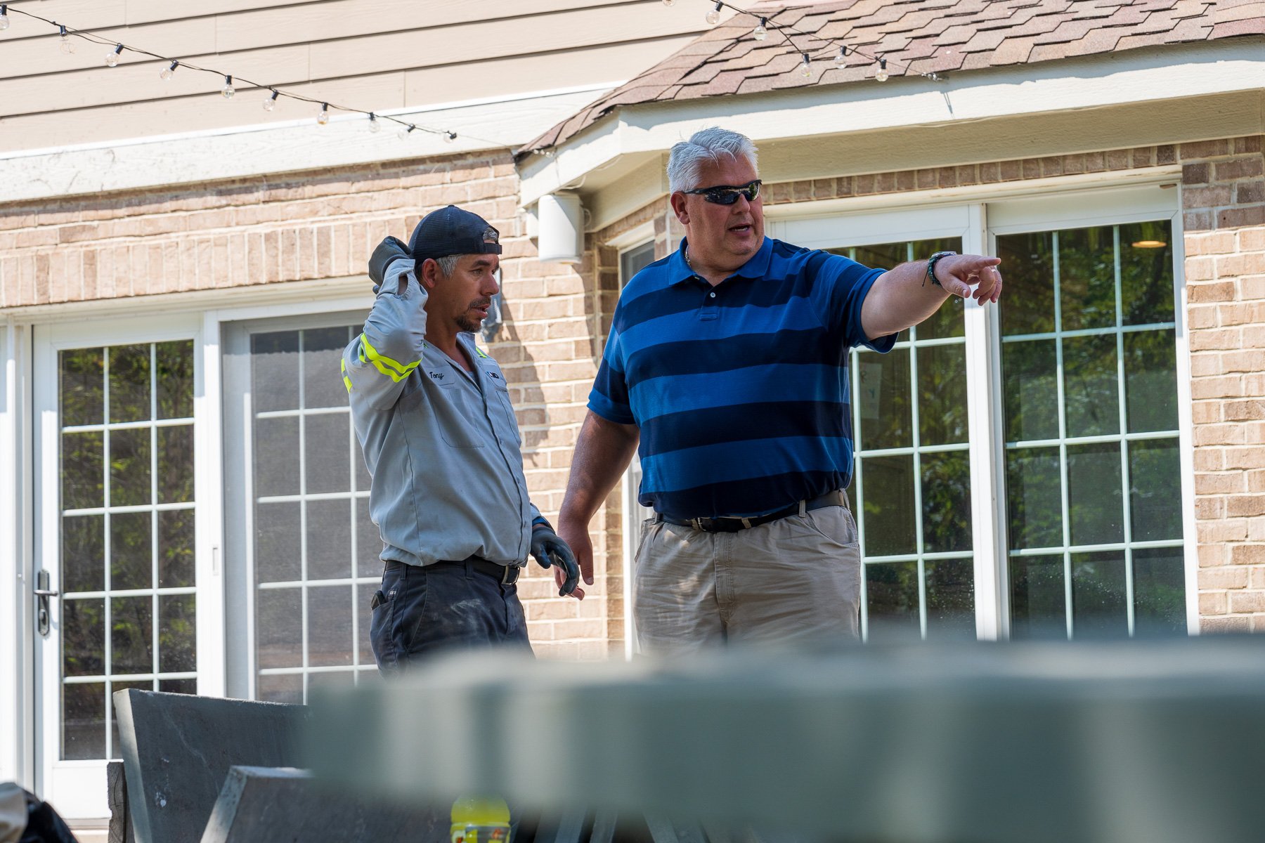 landscape construction crew and property manager reviewing a project