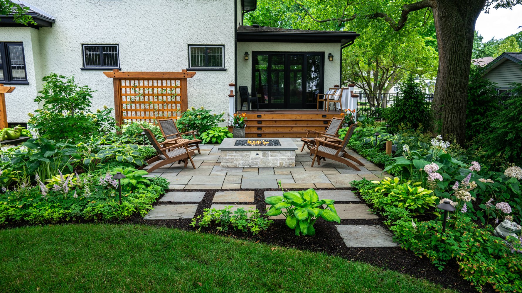 patio-pavers-natural stone-fire feature-pit-trellis-steps-plants-planting-hostas-steppingstones-lighting