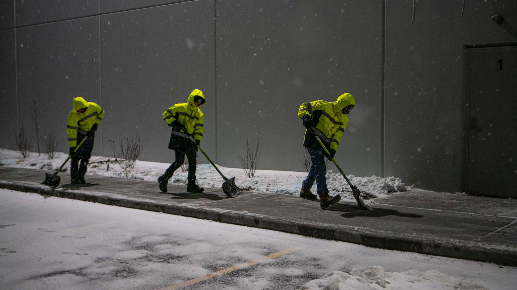 Commercial Snow Removal Warehouse team crew shoveling 8