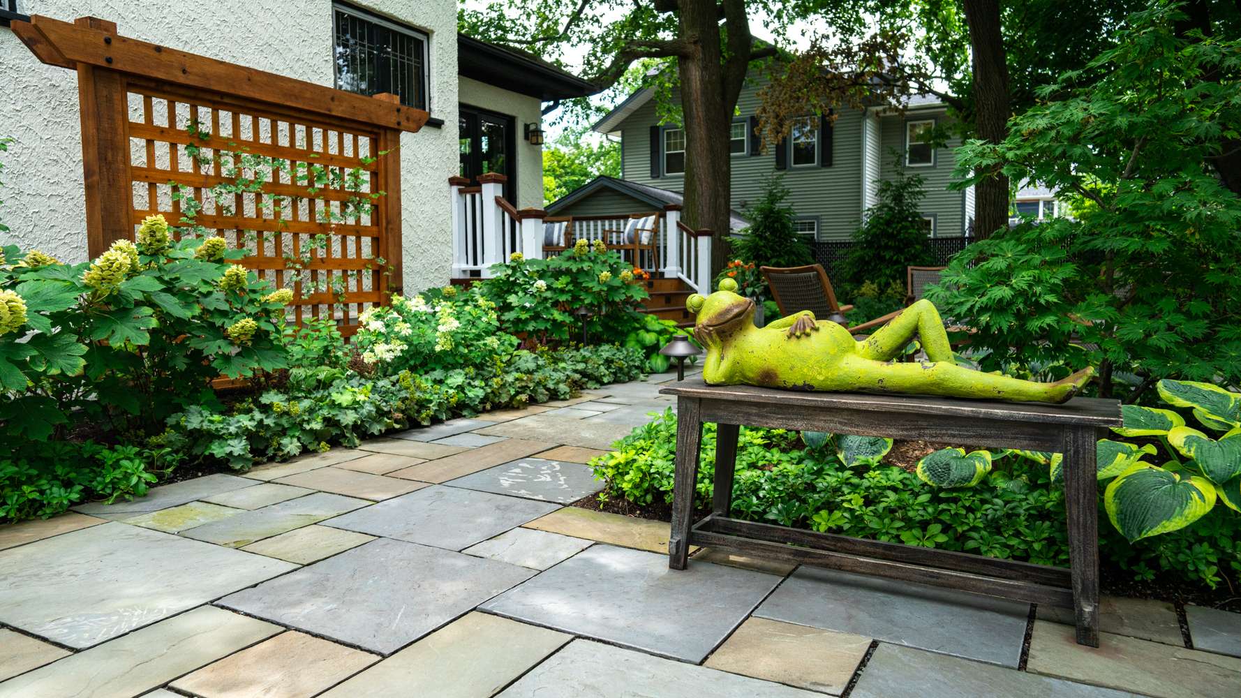 pathway-walkway-natural stone-pavers-sculpture-fire pit-fire feature-seating-planting-plants-hostas-shade-trellis-hydrangea