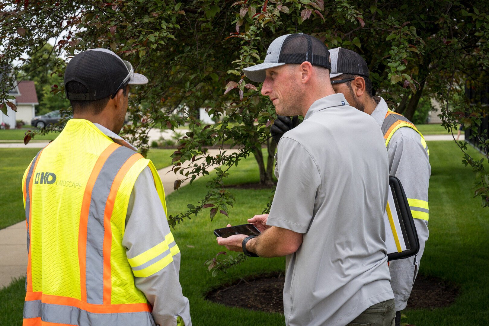 commercial HOA account manager and crew reviewing project